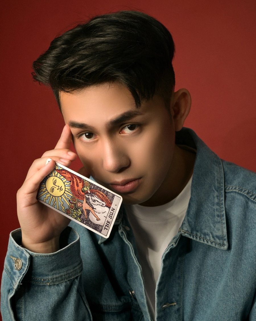 Jamison Ng holding a tarot card